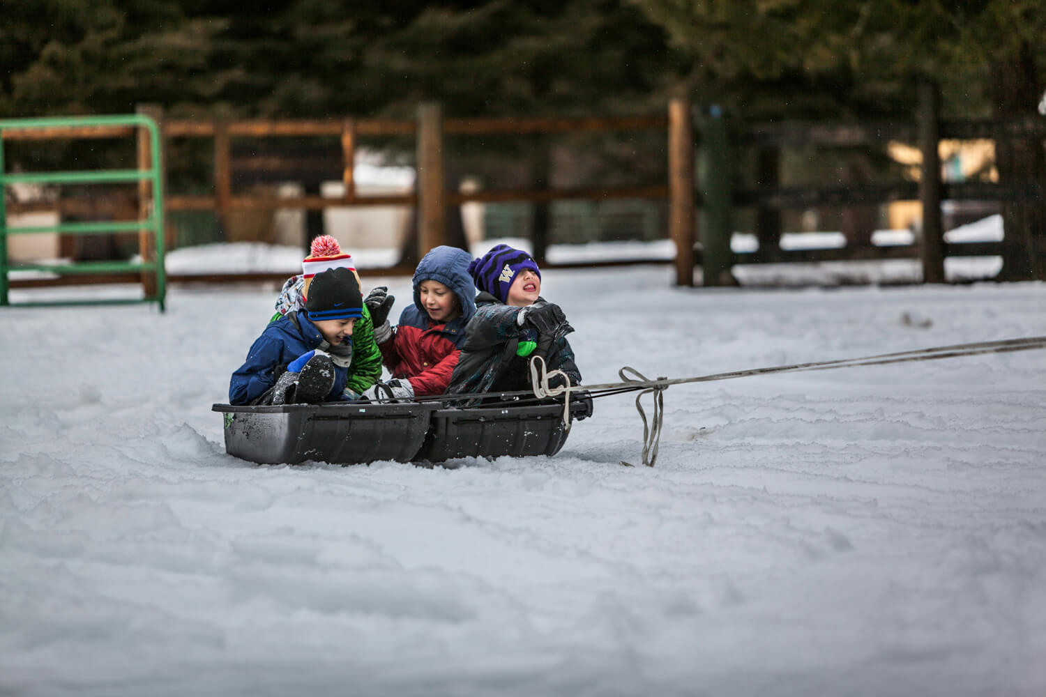Photo of four young boys being pulled in a sled. This photo is associated with an article called '9 awesome ideas for staying active even when it's cold outside."